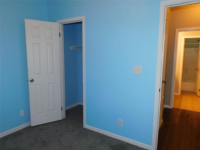 unfurnished bedroom featuring dark carpet