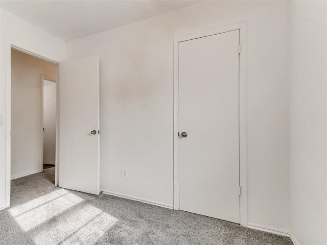 unfurnished bedroom with light colored carpet