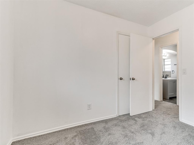 unfurnished bedroom with light colored carpet