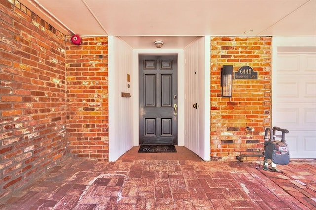 view of exterior entry with a garage