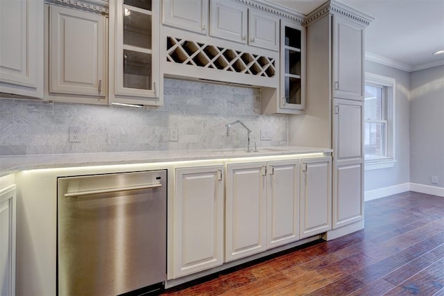 kitchen with stainless steel dishwasher, sink, white cabinets, ornamental molding, and dark hardwood / wood-style flooring