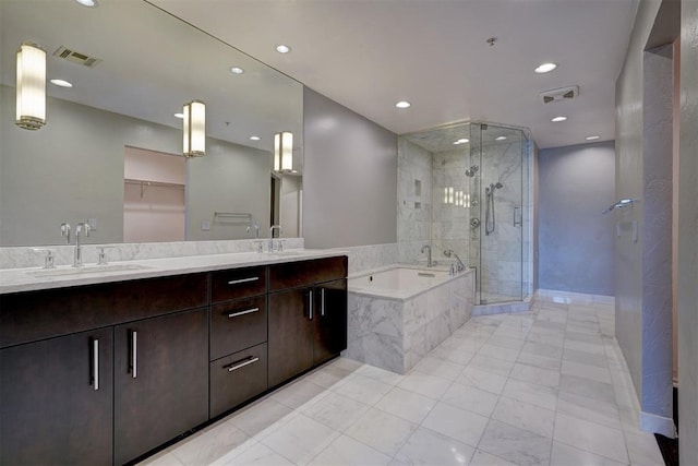 bathroom featuring vanity and separate shower and tub