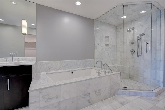 bathroom featuring vanity and separate shower and tub