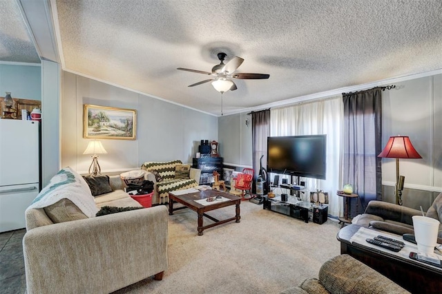 carpeted living room featuring a textured ceiling, ornamental molding, and ceiling fan