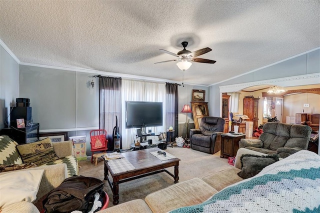 carpeted living room with ornamental molding, lofted ceiling, a textured ceiling, and ceiling fan