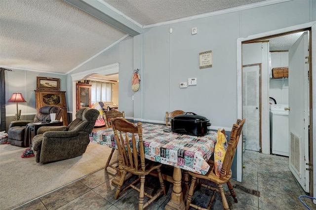 dining space featuring crown molding, lofted ceiling, washer / dryer, and a textured ceiling