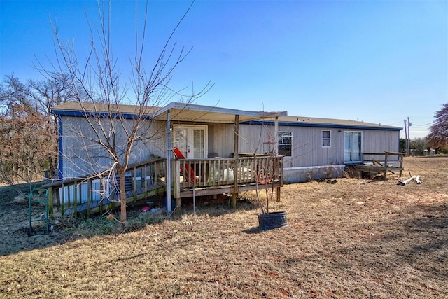 rear view of house featuring a wooden deck