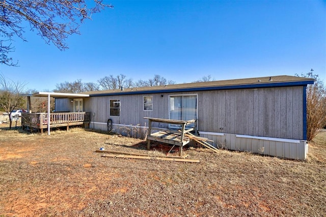 back of property featuring a deck