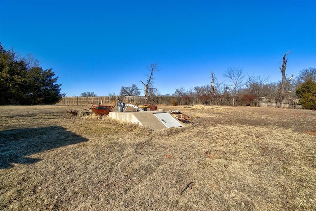 entry to storm shelter featuring a yard