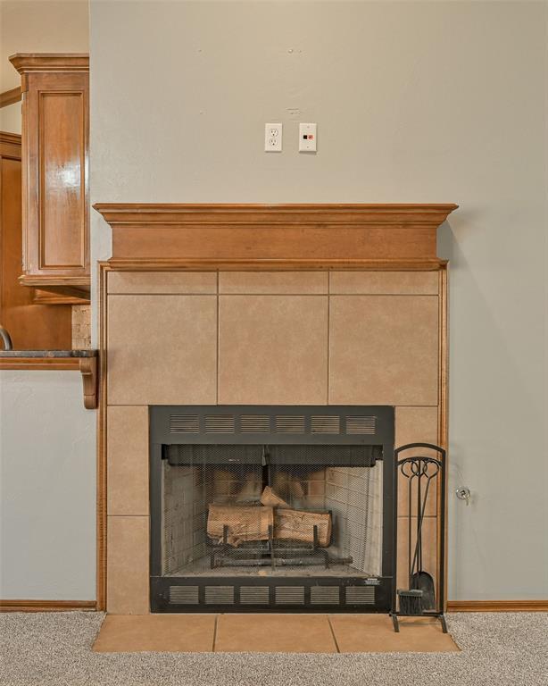 room details with carpet floors and a tile fireplace