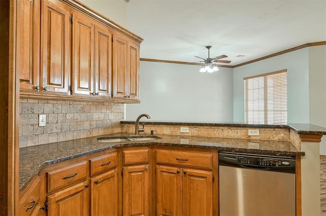 kitchen with dishwasher, sink, dark stone countertops, ornamental molding, and kitchen peninsula