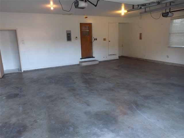 garage with a garage door opener and electric panel