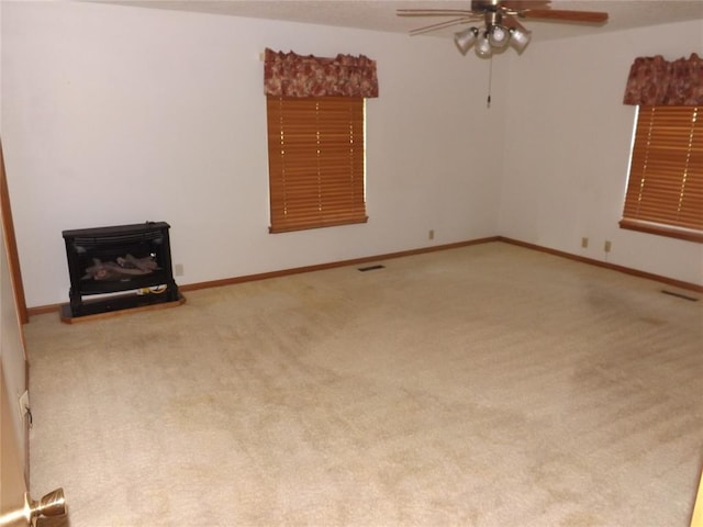 carpeted spare room with ceiling fan