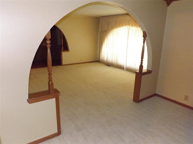 unfurnished room featuring light colored carpet