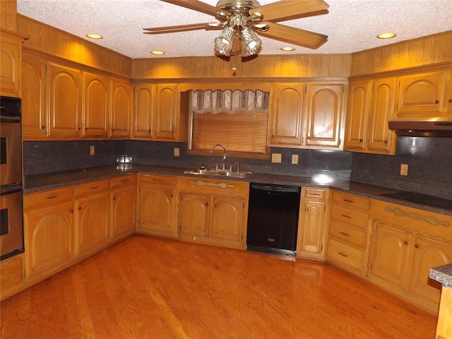 kitchen featuring ceiling fan, black appliances, sink, light hardwood / wood-style flooring, and a textured ceiling