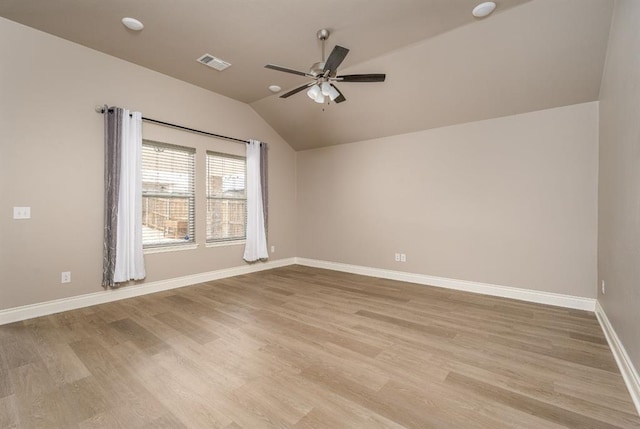 empty room with ceiling fan, light hardwood / wood-style flooring, and lofted ceiling