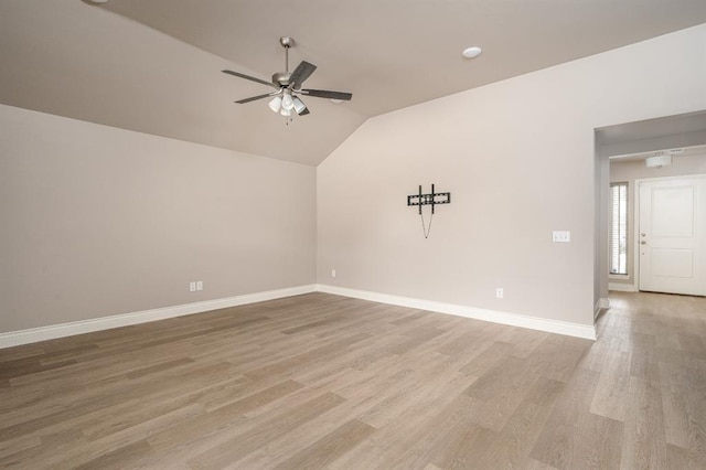 empty room with hardwood / wood-style floors, vaulted ceiling, and ceiling fan