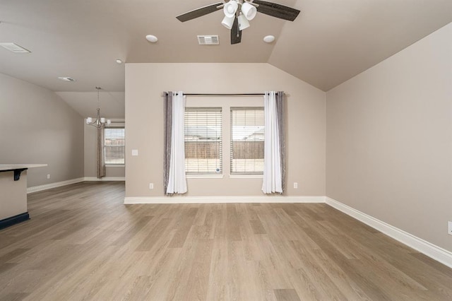 unfurnished living room featuring a healthy amount of sunlight, light hardwood / wood-style floors, and lofted ceiling