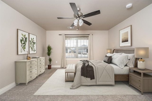 bedroom with ceiling fan and light carpet