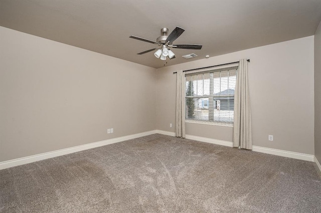 empty room with ceiling fan and carpet