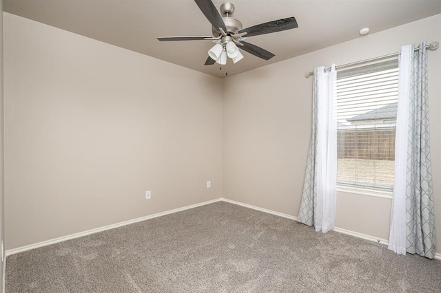 carpeted empty room featuring ceiling fan