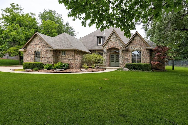 view of front of house featuring a front lawn and french doors