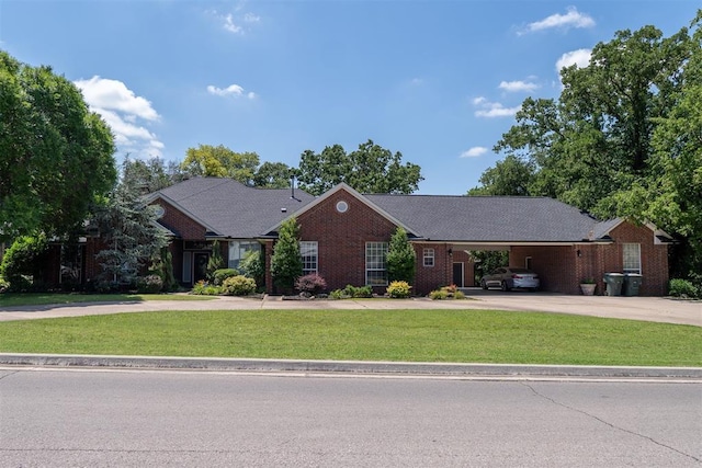 ranch-style home featuring a front lawn and a carport