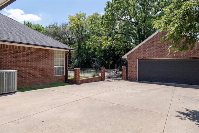 exterior space featuring a garage and central AC