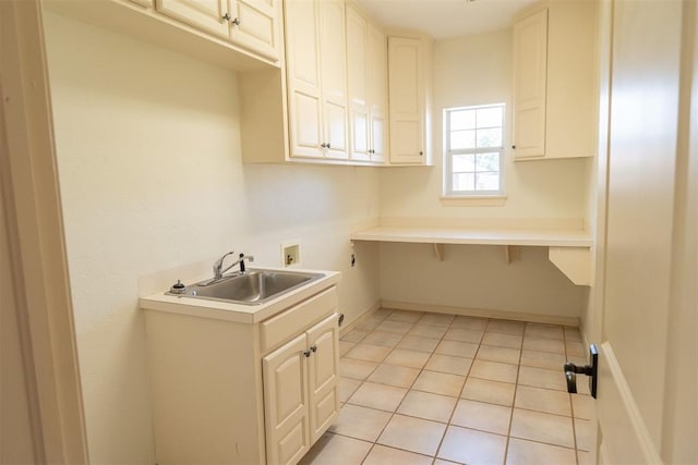 laundry room with washer hookup, cabinets, light tile patterned floors, and sink