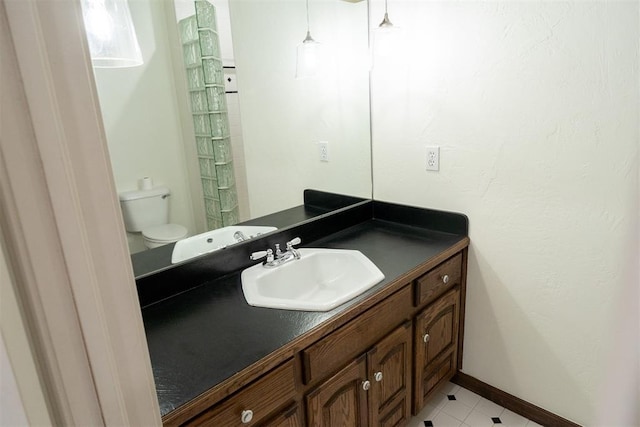 bathroom featuring toilet and vanity