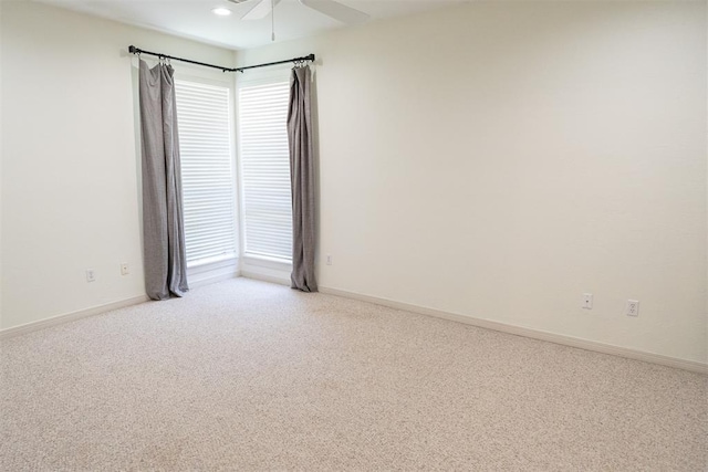 carpeted empty room featuring ceiling fan