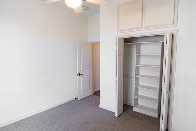 unfurnished bedroom with ceiling fan, a closet, and carpet