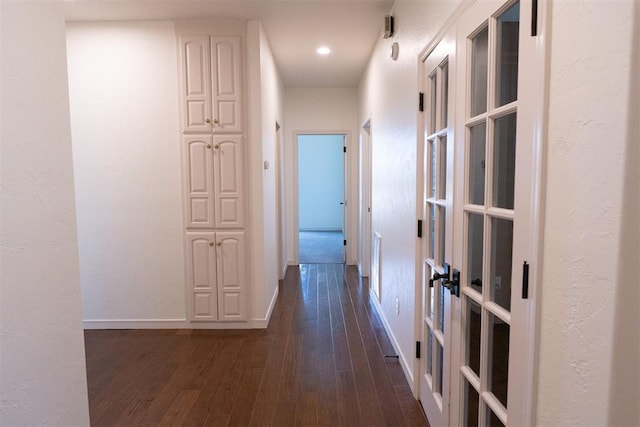 corridor with french doors and dark hardwood / wood-style floors