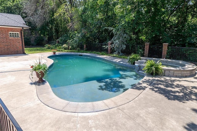 view of swimming pool with an in ground hot tub and a patio