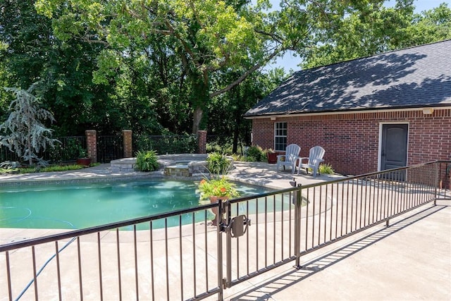 view of swimming pool featuring a patio area and an in ground hot tub