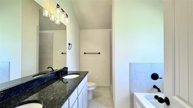 bathroom featuring toilet, a bathing tub, tile patterned flooring, and vanity