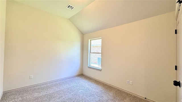 spare room with lofted ceiling and carpet flooring