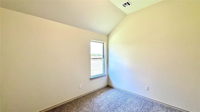 unfurnished room with lofted ceiling and carpet