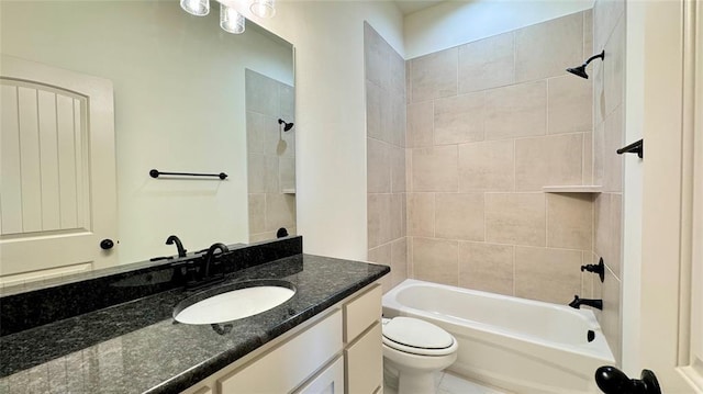 full bathroom with tiled shower / bath combo, vanity, and toilet