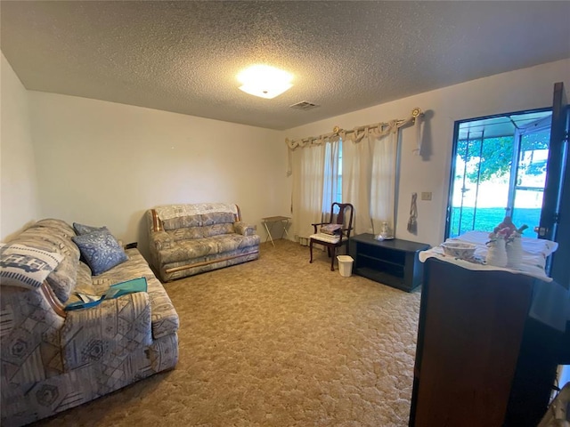 carpeted living room featuring a textured ceiling