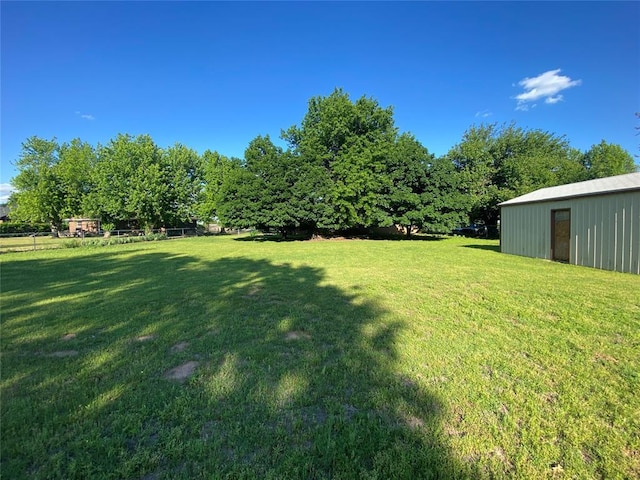 view of green lawn with an outbuilding