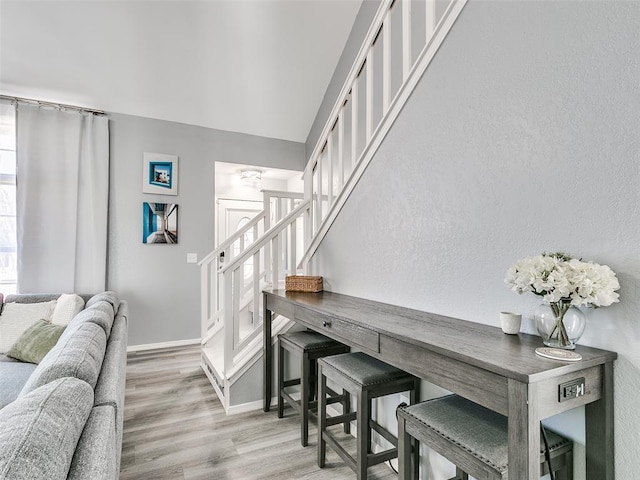 interior space with hardwood / wood-style floors and lofted ceiling