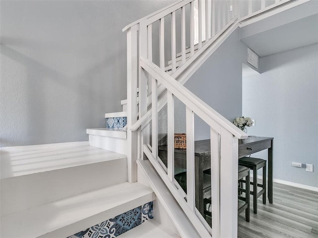 staircase featuring hardwood / wood-style flooring