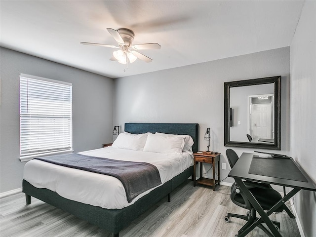 bedroom with ceiling fan and light hardwood / wood-style flooring