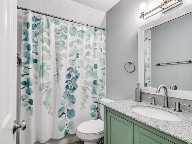 bathroom featuring vanity, toilet, and curtained shower