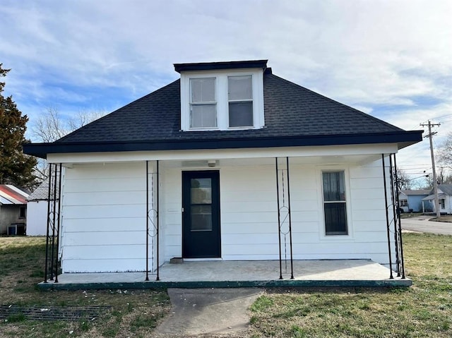 view of front facade with central AC unit and covered porch