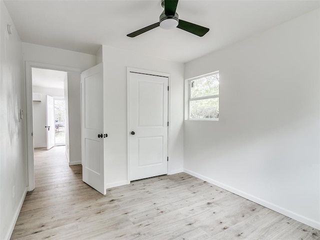 unfurnished bedroom with ceiling fan, a closet, and light wood-type flooring