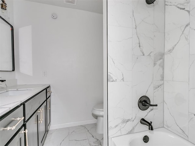 full bathroom with vanity, toilet, and tiled shower / bath