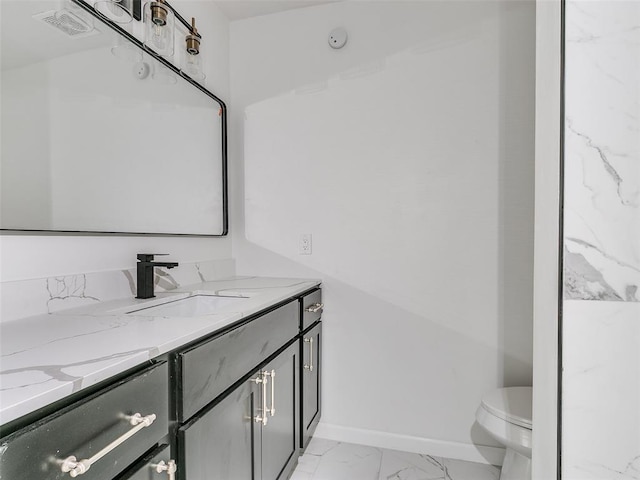 bathroom featuring toilet and vanity