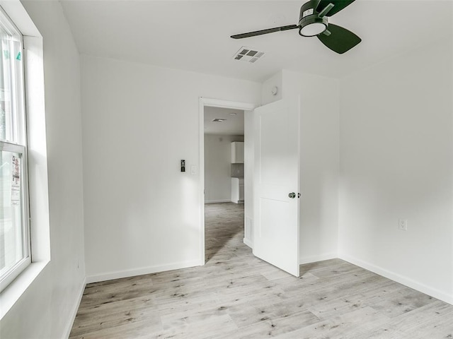 unfurnished room featuring light wood-type flooring and ceiling fan